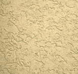 Textured beige stucco wall with an uneven, rough surface and irregular patterns, commonly used as exterior or interior wall finish in buildings.