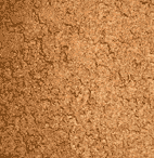 Close-up of a corkboard surface, showing its natural brown color and uneven, textured pattern.