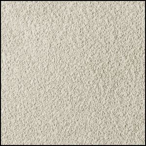 A close-up view of a textured, light beige carpet with a soft and slightly rough surface. The image shows a uniform, dense pattern of fibers.