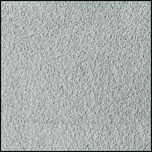 Close-up view of a light gray, textured surface resembling carpet or fabric, with a slightly speckled and soft, fibrous appearance.
