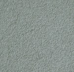 Close-up view of a textured light blue surface, resembling a rough plaster or stucco wall with an uneven, grainy pattern.