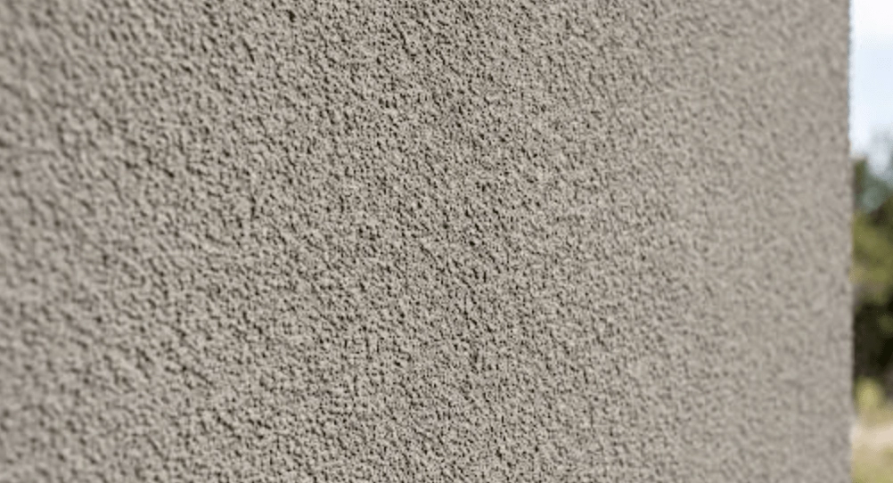 Close-up view of a grey, textured exterior wall.
