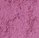 Close-up of a textured pink powder, possibly makeup such as blush or eyeshadow, showing a slightly uneven and rough surface.