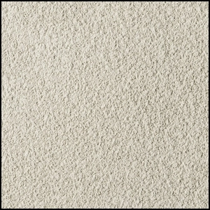 A close-up view of a textured, light beige carpet with a soft and slightly rough surface. The image shows a uniform, dense pattern of fibers.