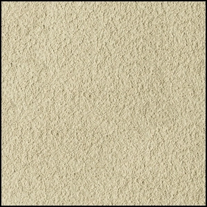 Close-up view of a beige, sandy, and slightly rough textured surface, resembling fine sandpaper or compacted sand.